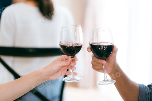 Preview: Family and friends raise their glasses to celebrate a joyful evening filled with laughter wine