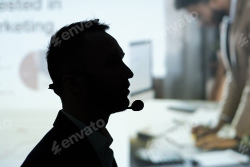 Preview: Profile outline of contemporary male broker speaking in microphone at seminar