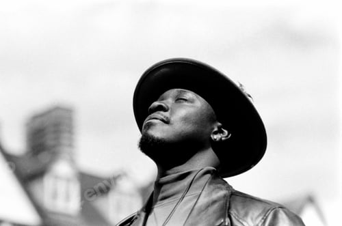 Preview: Black and white portrait of man relaxing with eyes closed and enjoying sunlight.