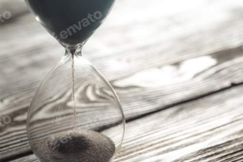 Preview: Modern hourglass on wooden background. Close up