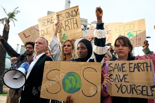 Preview: Serious Muslim woman holding a banner in a protest by a group of people at a demonstration