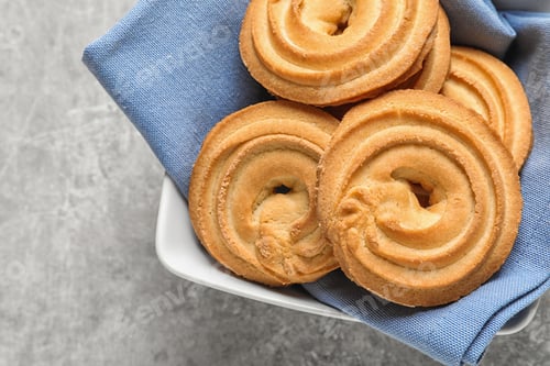 Preview: Bowl with Danish butter cookies on grey table, top view