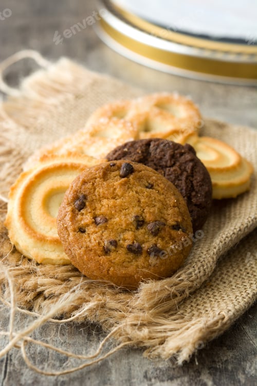 Preview: Chocolate chip cookies resting on rustic burlap with danish butter cookies