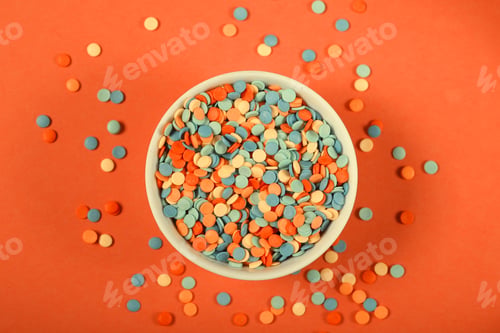 Preview: Small Round Candies Lie On A Bright Background