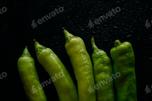 Preview: Green chili pepper on black floor