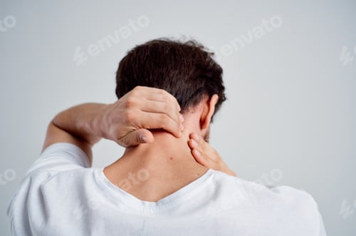Preview: emotional man in a white t-shirt stress medicine pain in the neck studio treatment