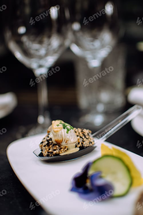 Preview: Piece of sushi on a spoon. Dark background.