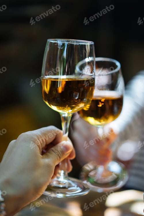 Preview: Glasses of white wine clanging together