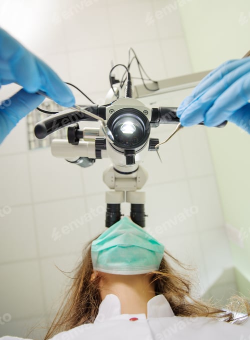 Preview: First person view on female dentist using microscope