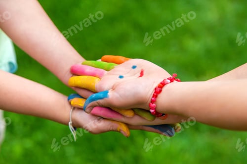 Preview: Hands of a child with a drawn smile. Selective focus.