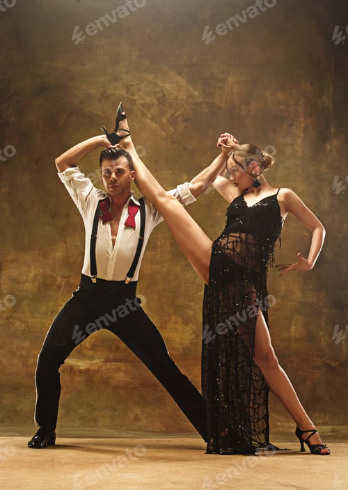 Preview: Flexible young modern dance couple posing in studio.