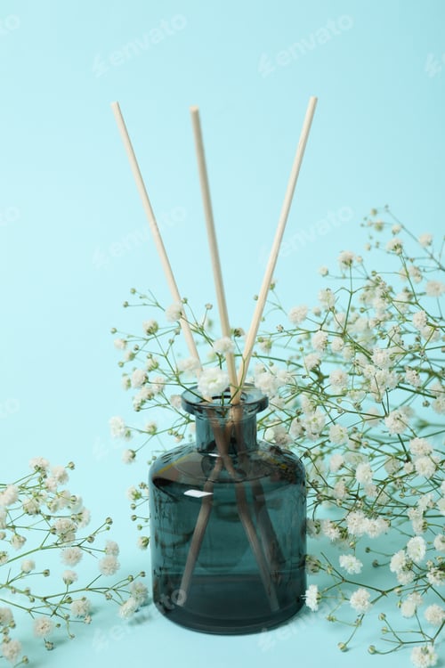 Preview: Aroma scent diffuser and flowers on blue background