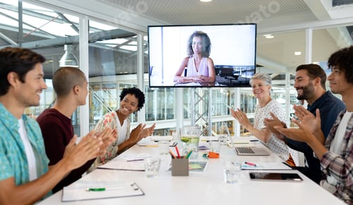 Preview: Diverse business people attending video conference at conference room