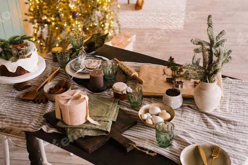 Preview: Festive Table Set for Christmas Dinner on the Background of Tree and Lights