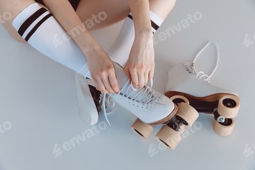 Preview: Close-up partial view of hipster girl wearing roller skates isolated on grey