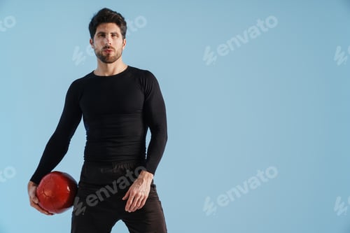 Preview: Handsome athletic sportsman posing with medicine ball