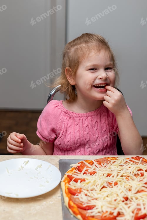 Preview: Happy Girl Enjoying Homemade Pizza at the Table