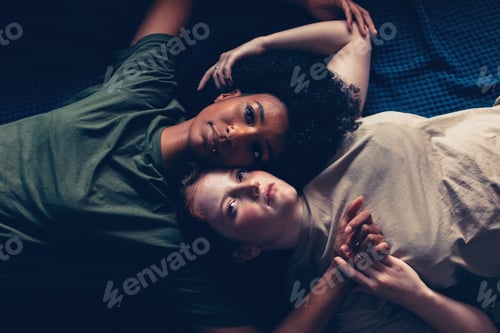 Preview: directly above of multiethnic diverse young female ladies couple