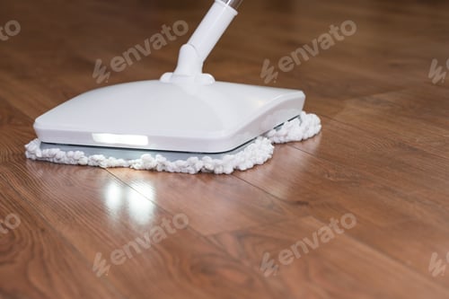 Preview: A man washes the floor in an apartment with a modern electric mop