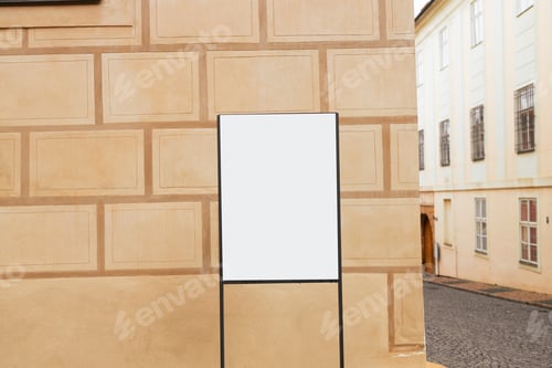 Preview: Mockup of the blank street city outdoor advertising square billboard in black frame at park entrance