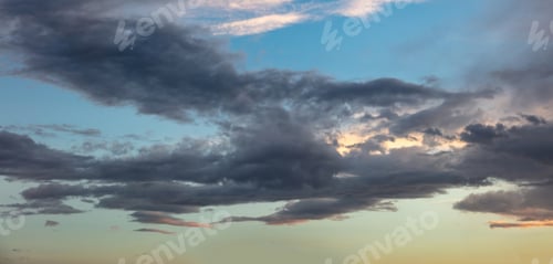 Preview: Twilight light color the cloudy sky. Cloud on blue sky background. Cloudscape grey and orange shade.