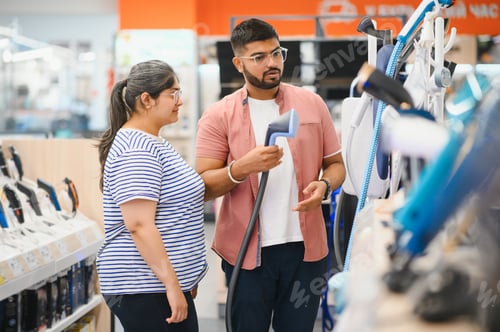 Preview: An Indian couple chooses an iron steamer in an electronics store