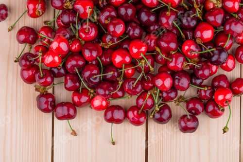 Preview: Fresh cherries on wooden table in the closeup.