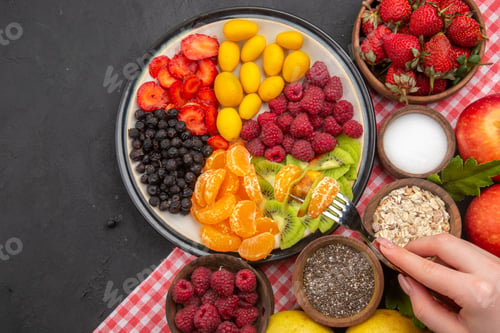 Preview: top view tasty sliced fruits with fresh berries and fruits on a dark background color mellow exotic