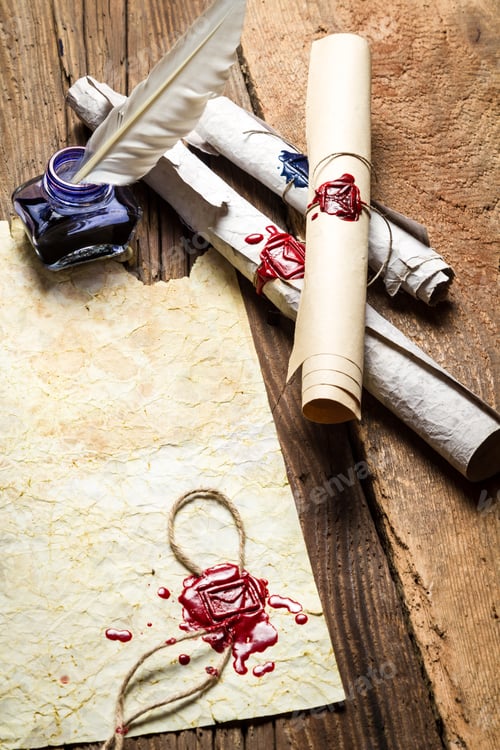 Preview: Inkwell and ancient scrolls on wooden table