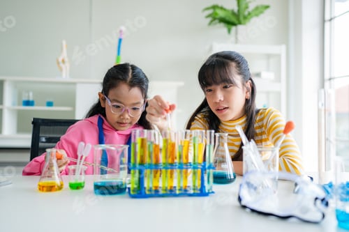 Preview: Group of young asian schoolgirls learning research and doing experiment.