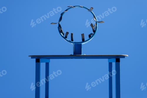 Preview: Low angle view of basketball hoop against blue sky