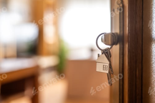 Preview: House-shaped keys are hanging from the door knob of a new home