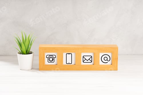 Preview: Contact us icons in modern wooden frame on desk