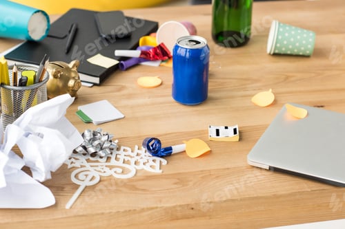 Preview: close up view of soda drink, party decorations and laptop on tabletop in office