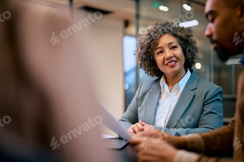 Preview: Smiling insurance agent having a meeting with her client in the office.