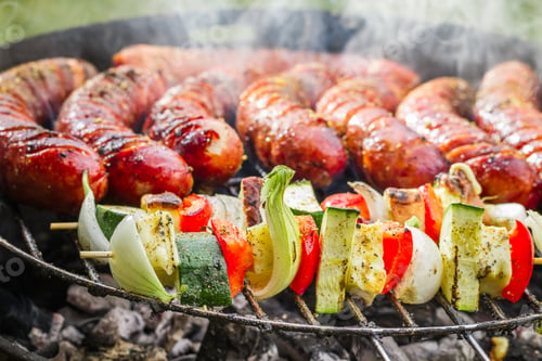 Preview: Closeup of sausages and skewers on the grill