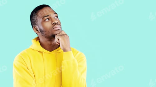 Preview: Black Man Thinking Touching Chin Looking Aside, Blue Background, Panorama