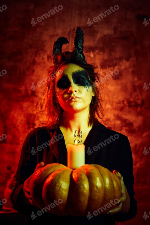 Preview: Female model in halloween outfit posing with on a red background. Gorgeous girl in clothes