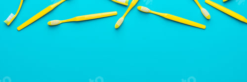 Preview: Top View Of Yellow Toothbrushes Over Turquoise Blue Background With Copy Space