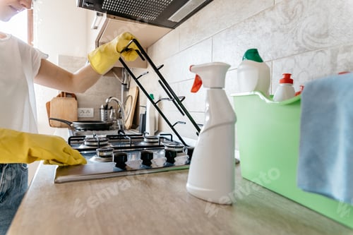 Preview: Woman cleaning the kitchen of her apartment.