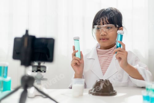 Preview: Asian school girl making easy chemistry experiments and recording a video for his followers,