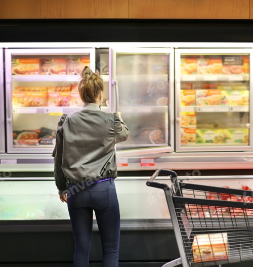 Preview: Woman Choosing Frozen Food From A Supermarket Freezer