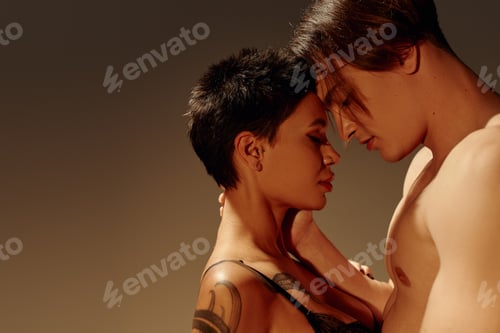Preview: side view of sexy tattooed woman and shirtless man standing face to face with closed eyes isolated