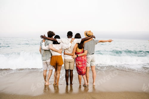 Preview: Group of young people hugging each other and enjoying summer at beach