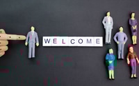 Preview: Welcome Message with Miniature Figures on Dark Background