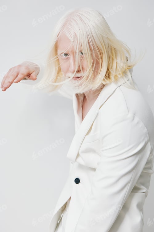 Preview: Portrait of a model with long white hair, wearing an elegant white suit The model has a striking