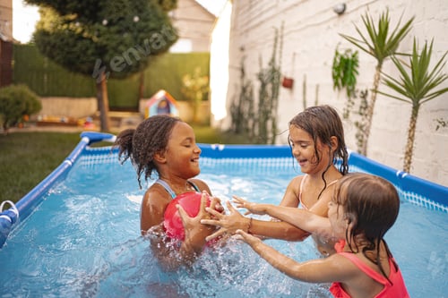 Preview: Three children playing with a ball in a backyard swimming pool
