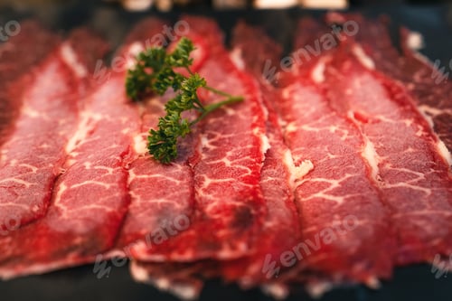 Preview: Sliced beef shabu in a black plate in a restaurant