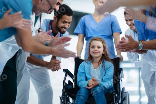 Preview: Medical staff clapping to little girl patient who recovered from serious illness.