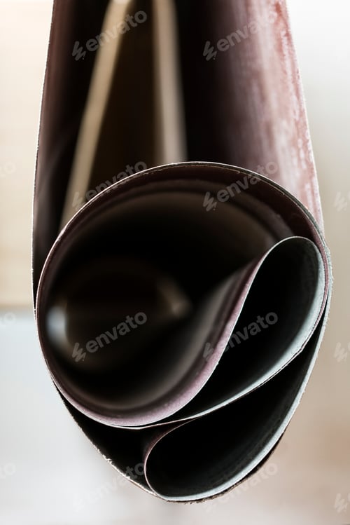 Preview: Closeup of sanding belts ready to be used in a wood working shop.